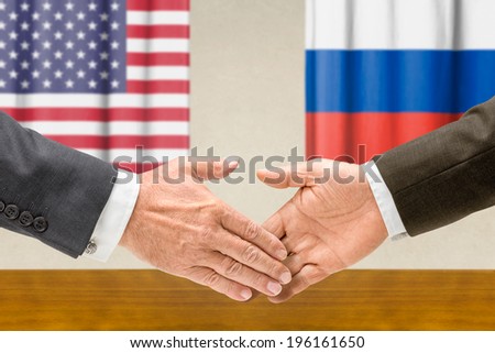 Representatives of the USA and Russia shake hands