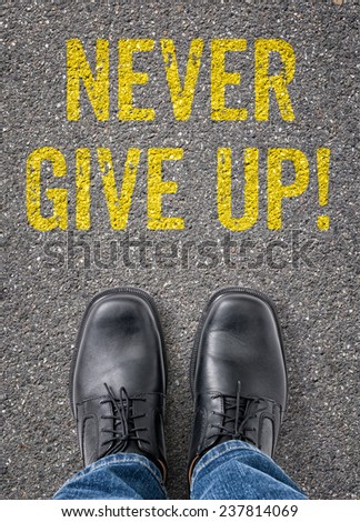 Text on the floor - Never give up