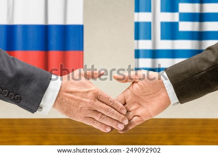 Representatives of Russia and Greece shake hands