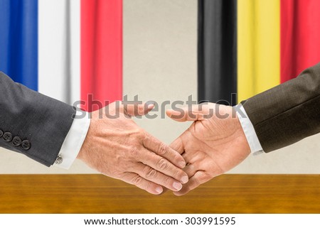 Representatives of France and Belgium shake hands