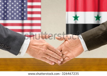Representatives of the USA and Syria shake hands
