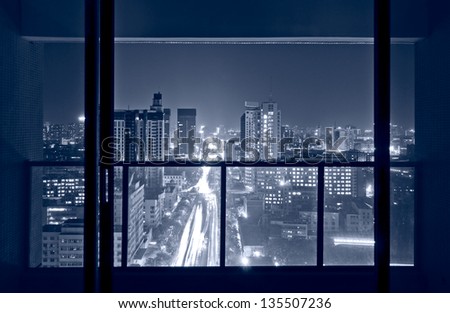 A bird\'s eye view of the city night view outside the window