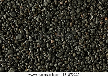 Black stones on a Black sand beach as a background. Hawaii, Maui, USA