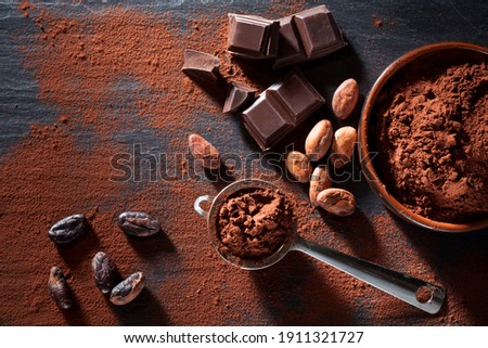  Cocoa beans, chocolate and cocoa powder still life