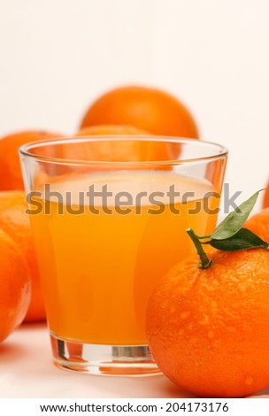 Fresh orange fruits  and a glass of orange fruit  juice isolated on white background