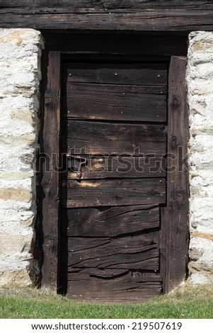 Old wooden door of a house in Swiss Alps village