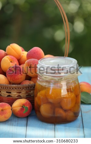 Apricot jam jar and ripe apricots basket