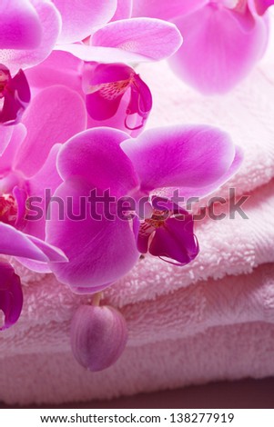 luxury wellness towel with pink orchid flower