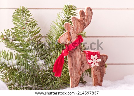wooden elk christmas decoration with snow and fir