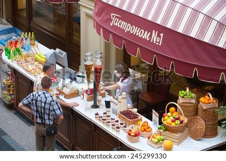 MOSCOW - JULY 29: Vendor selling fruit juice to buyers in GUM store on July 29, 2014 in Moscow.
