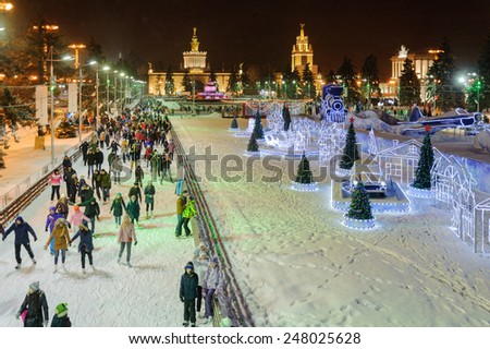 MOSCOW - JANUARY 4: People skating near decorations and illuminations at VDNKh park at winter night on January 4, 2015 in Moscow.