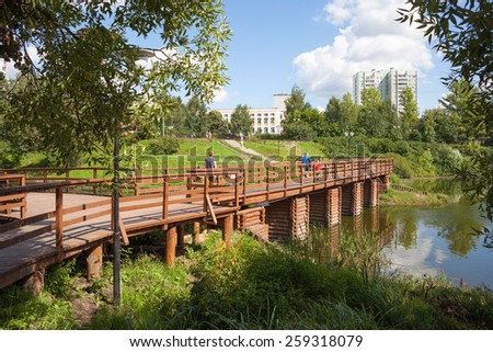 MOSCOW - AUGUST 2: Wooden bridge and Chermyanka river in Heritage Village Park in Bibirevo district on August 2, 2013 in Moscow. Bibirevo is district of North-Eastern part of Moscow, Russia.