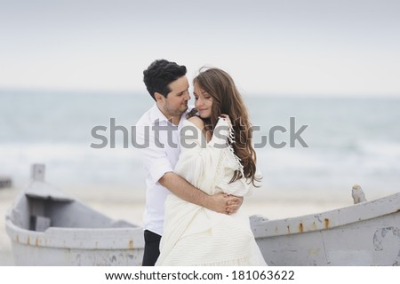 Bride and groom looking at each other on a photo session near the sea