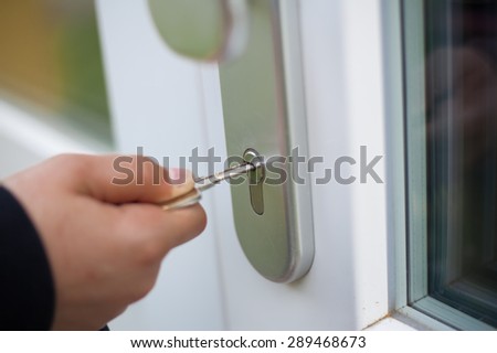 Closeup unlocking outdoor security doors (shallow DOF)