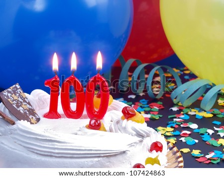 Birthday-anniversary cake with red candle showing Nr. 100