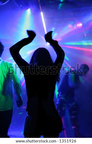 dancing woman in motion in front of laser lights