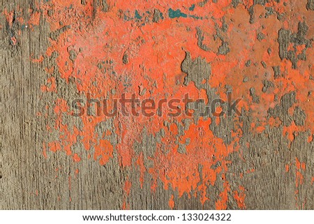 close up shot of old orange paint texture peeling off wood plank background