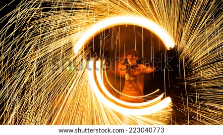 Rayong, Thailand - October, 12, 2014 : steel wool spinning in amazing fire show on the beach at night on October, 12, 2014 at Samed Island, Rayong, Thailand.