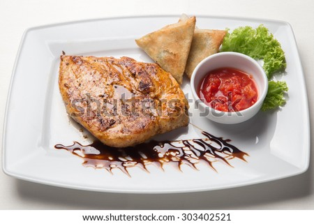 Fish with sauce on white plate. white background