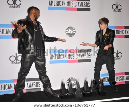 LOS ANGELES, CA - NOVEMBER 21, 2010: Usher & Justin Bieber (right) at the 2010 American Music Awards at the Nokia Theatre L.A. Live.