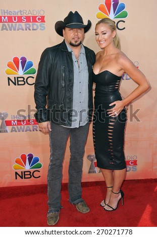 LOS ANGELES, CA - MARCH 29, 2015: Jason Aldean & Brittany Kerr at the 2015 iHeart Radio Music Awards at the Shrine Auditorium.