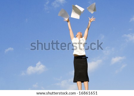 business woman throwing work papers in air