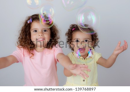 excited happy  kids children little girls playing with bubbles