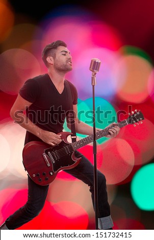 male performer singing live performance with guitar