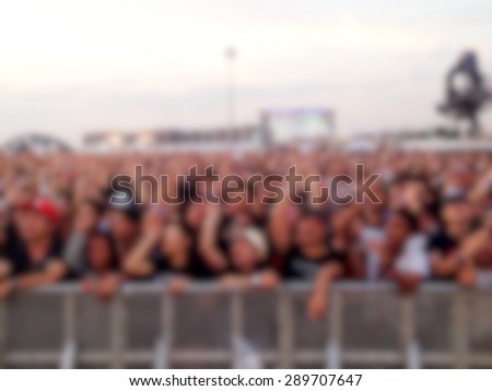 Blur image of people watching outdoor concert