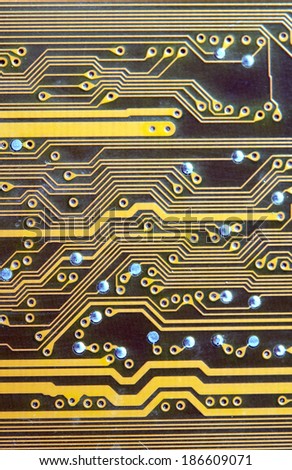 Close-up photo of circuit board in gold and black.