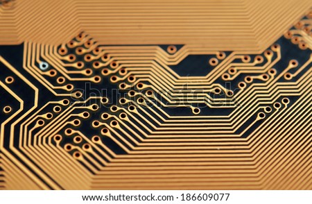 Close-up photo of circuit board in gold and black.