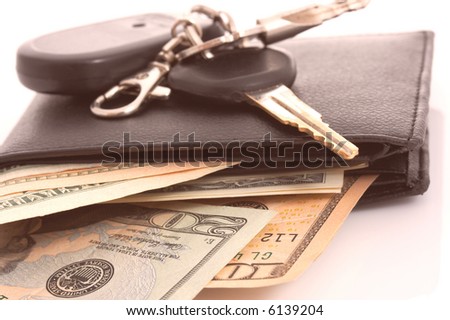 Car keys on a leather wallet with money
