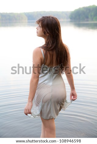 Woman Wading in Lake with Wet Dress