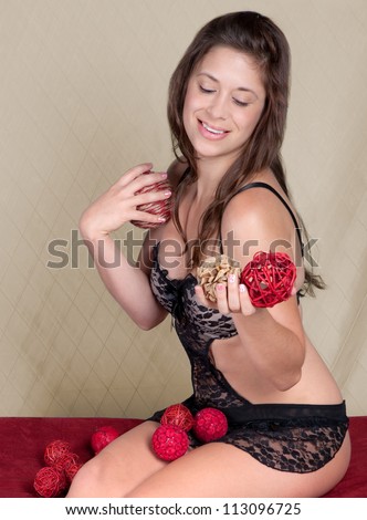 Pretty Woman in Lingerie Holding Decorative Spheres