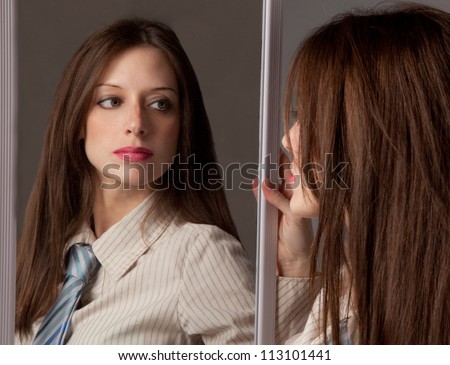 Beautiful Woman Looking At Self In Mirror