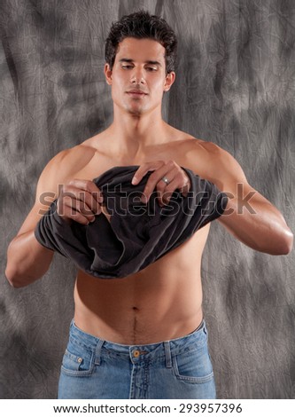 Attractive Man Putting Shirt On