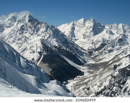 A view up the Maroon Creek Valley seen from the top of Aspen Highlands.  On display are three of Colorado\'s fourteeners: (L to R) Pyramid Peak, South and North Maroon Peak.