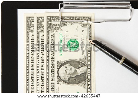 Dollars, pen and paper sheet on binder