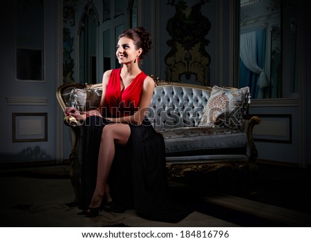 Young woman sit on sofa at ancient room (normal version)
