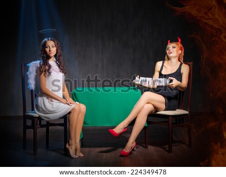 Angel and devil at dark room