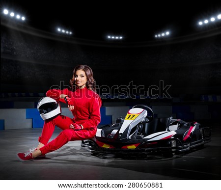 Young girl karting driver at sports hall