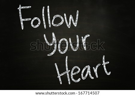 follow your heart quote written with chalk on blackboard