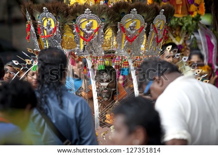 SERANGOON, SINGAPORE - JANUARY 27: Male Hindu devotee carries a kavadi at Thaipusam festival on January 27, 2013 in Singapore. Hindu festival to worship God Muruga.