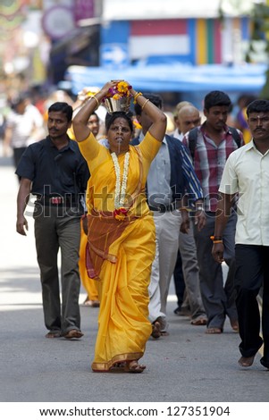 SERANGOON, SINGAPORE - JANUARY 27: Female Hindu devotee carries a kavadi at Thaipusam festival on January 27, 2013 in Singapore. Hindu festival to worship God Muruga.