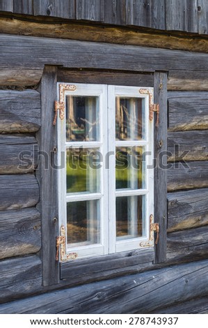 Rustic cottage window in old wooden rural house