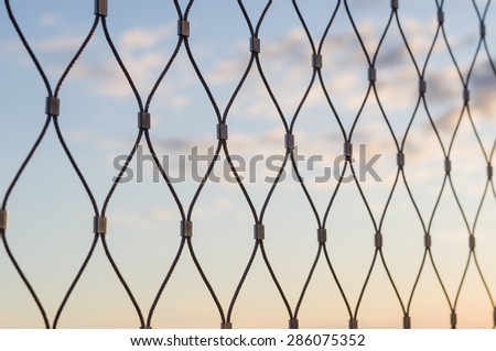 Metal mesh wire fence defocus blur closeup