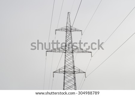 Electric high voltage power post, abstract view in morning haze