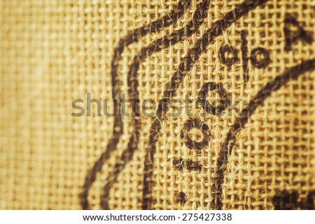 Split toned image of one hundred percent painted on a rustic burlap sack