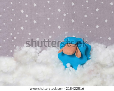 symbol of 2015 handmade sheep in the clouds,  textile background with stars