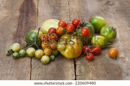Tomatoes, cooked with herbs for the preservation on the old wooden table.